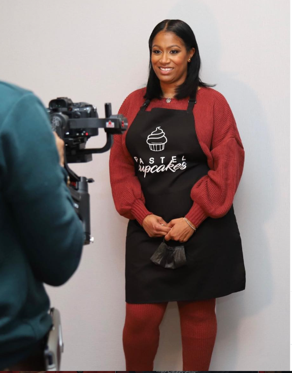 Monique Riddock, founder and head baker of Pastel Cupcakes, in her branded apron
